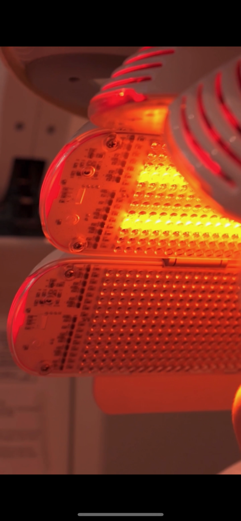 Close-up of red LED indicator panels on a device, with visible circuit boards and orange glow.